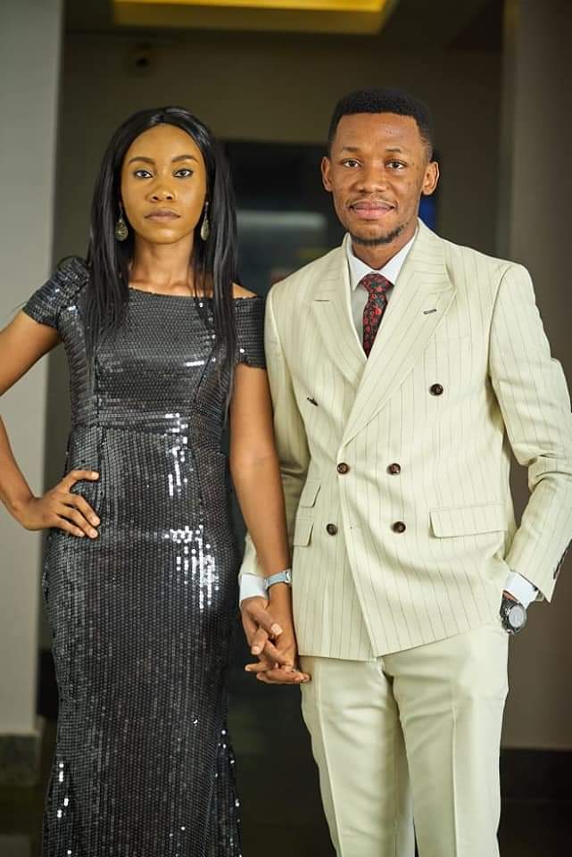Apostle Edu standing with his wife